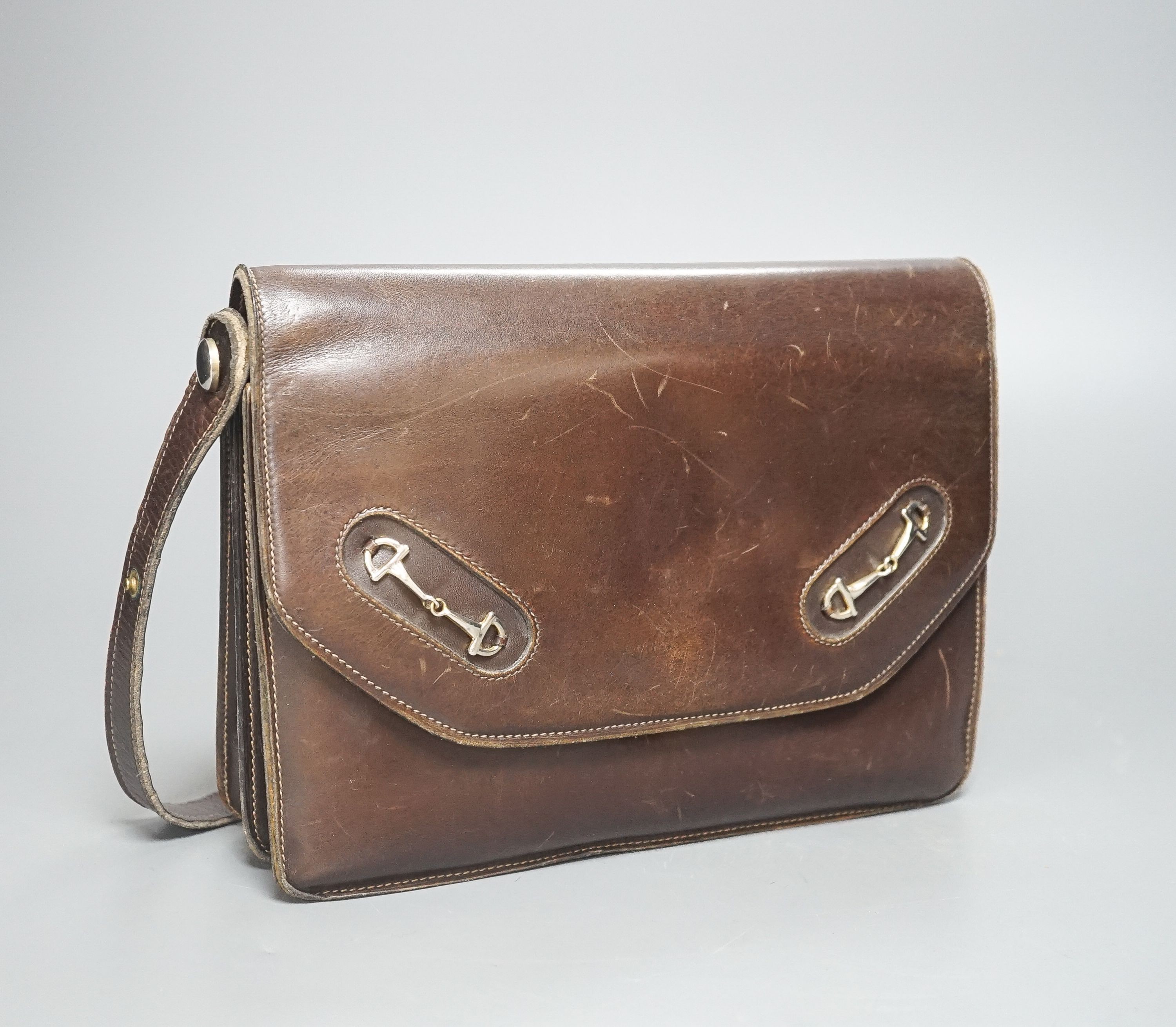 A vintage brown leather handbag stamped 